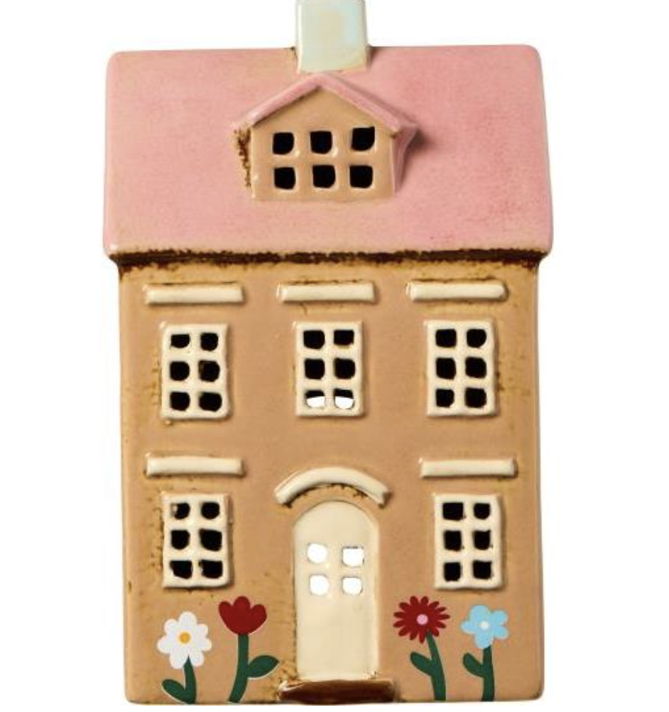 Maison avec bougies chauffe-plat, fleurs de Nyhavn et toit rose pâle